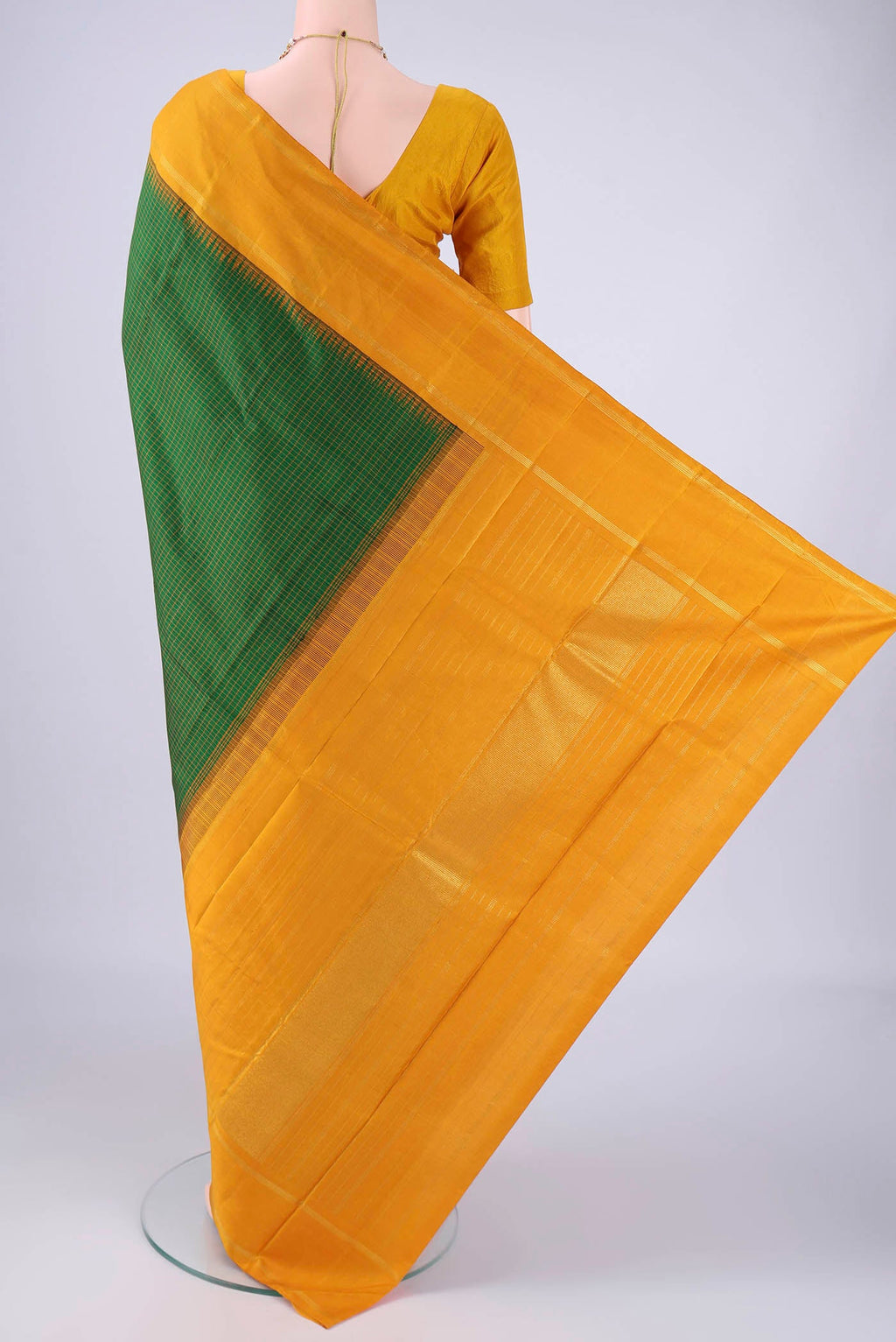 Flat view of Green Kanchipuram Silk Saree with Checked design on the body and Zari Border. 