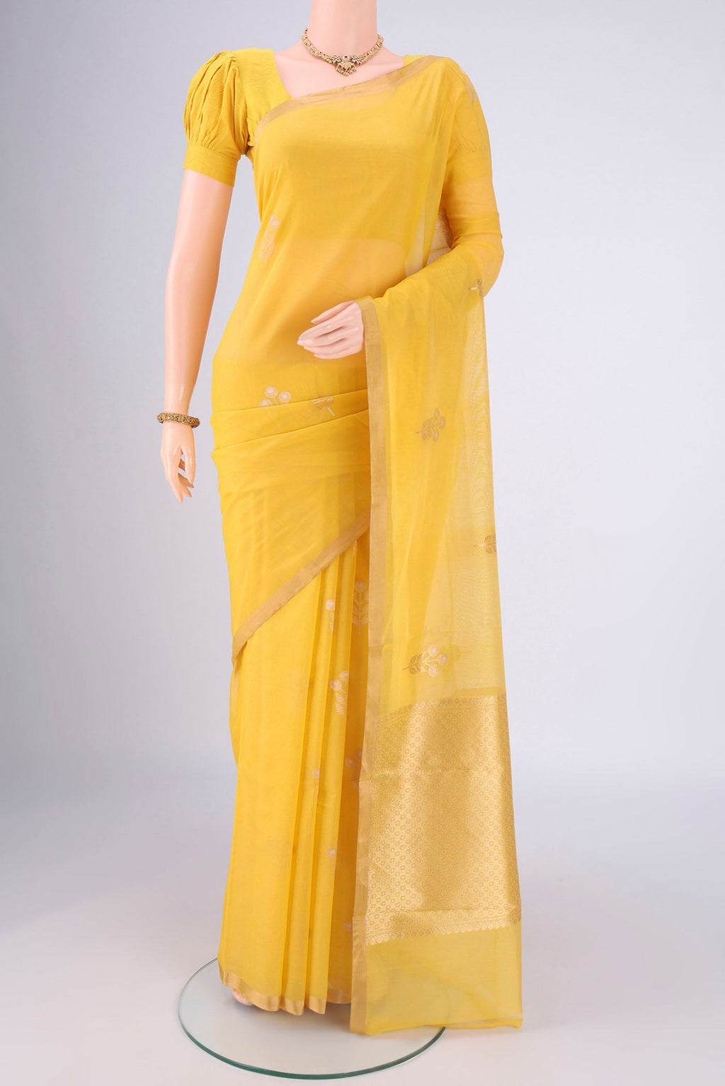 Lemon Yellow Chanderi Silk Cotton Saree with Zari Butta on the body and Zari Border.  displayed on a mannequin