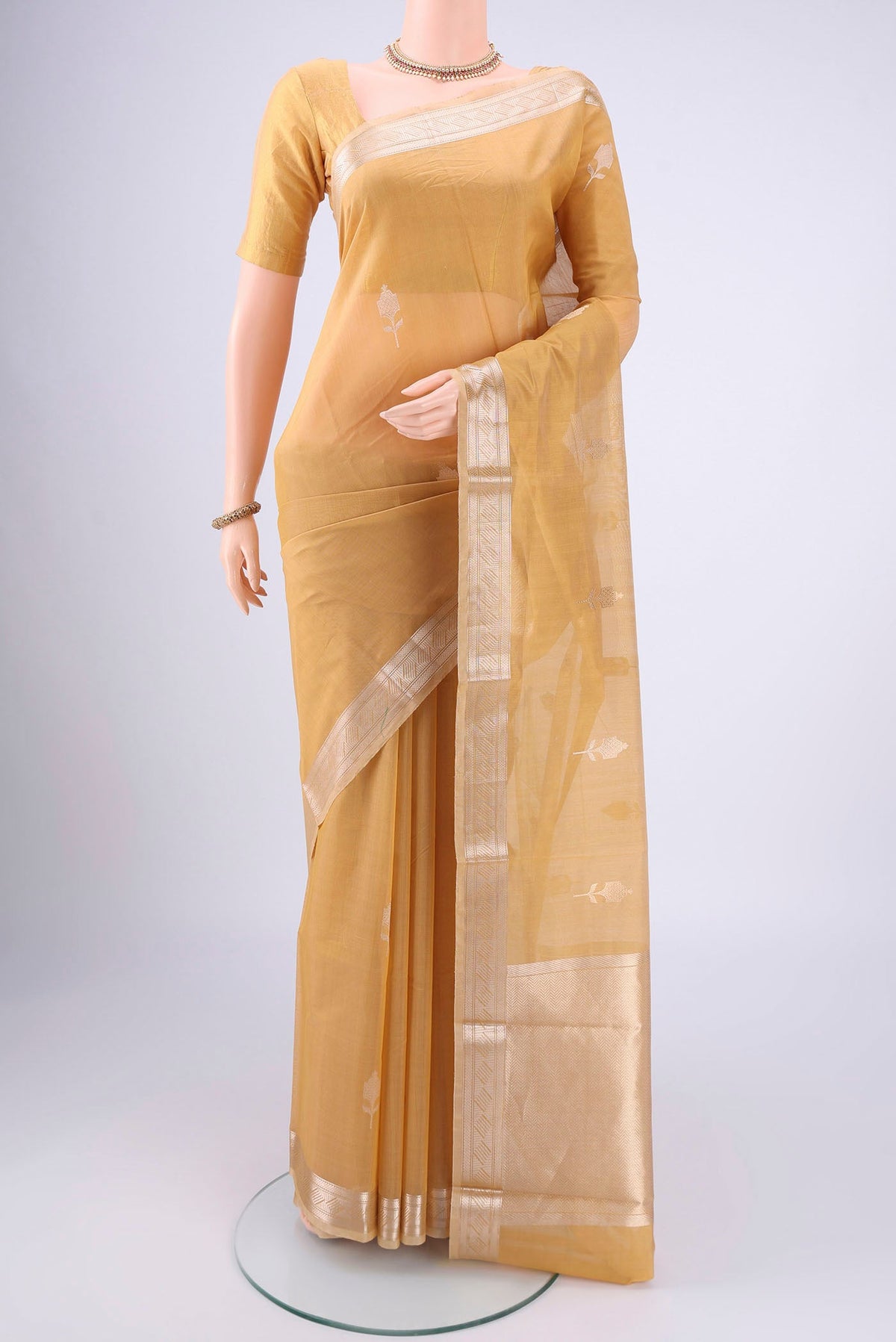 Dark Beige Chanderi Silk Cotton Saree with Zari Butta on the body and Zari Border.  displayed on a mannequin