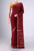 Maroon Uppada Silk Saree with Zari And Thread Butta on the body and Zari Border.  displayed on a mannequin