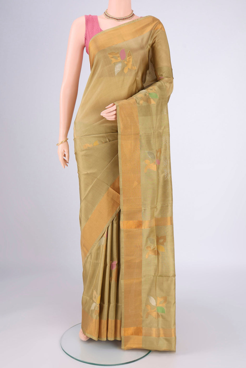 Beige Uppada Silk Saree with Zari And Thread Butta on the body and Zari Border.  displayed on a mannequin