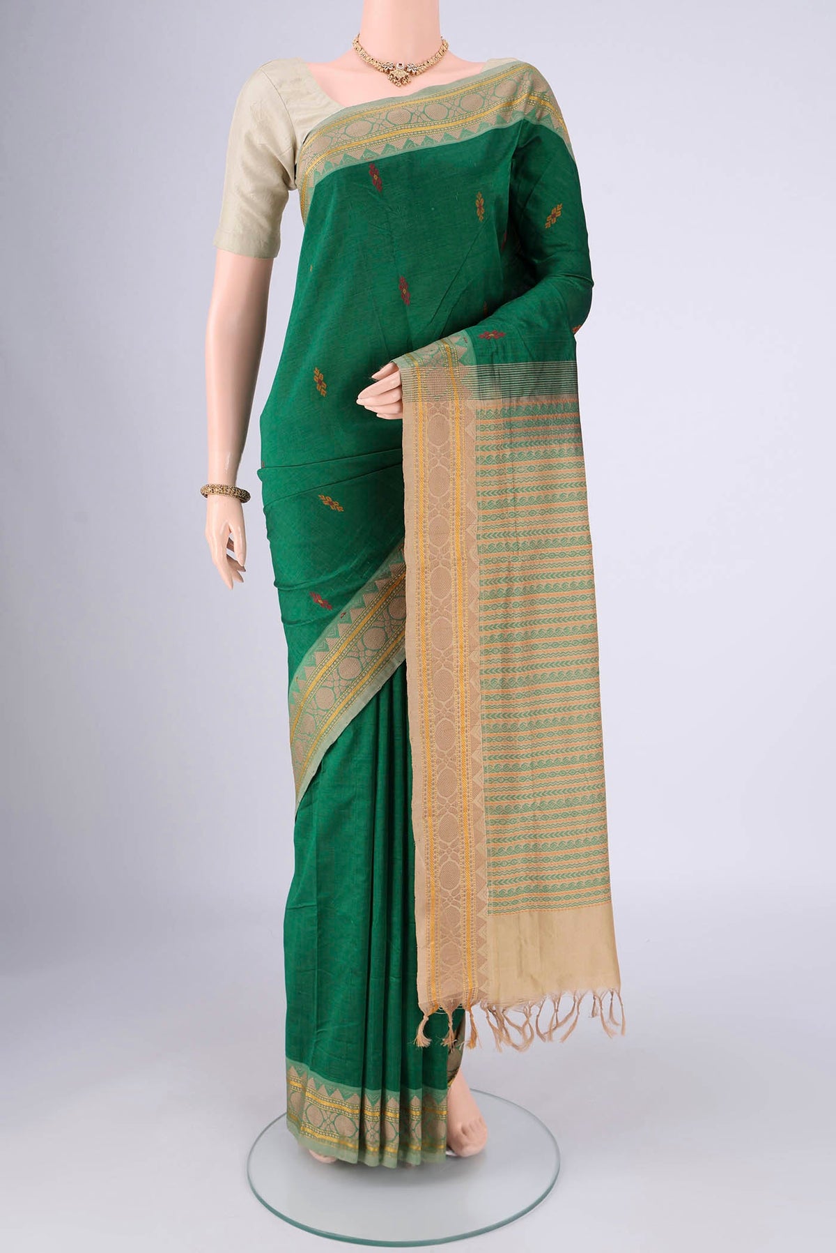 Bottle Green Blended Poly Cotton Saree with Thread Butta on the body and Thread Border.  displayed on a mannequin