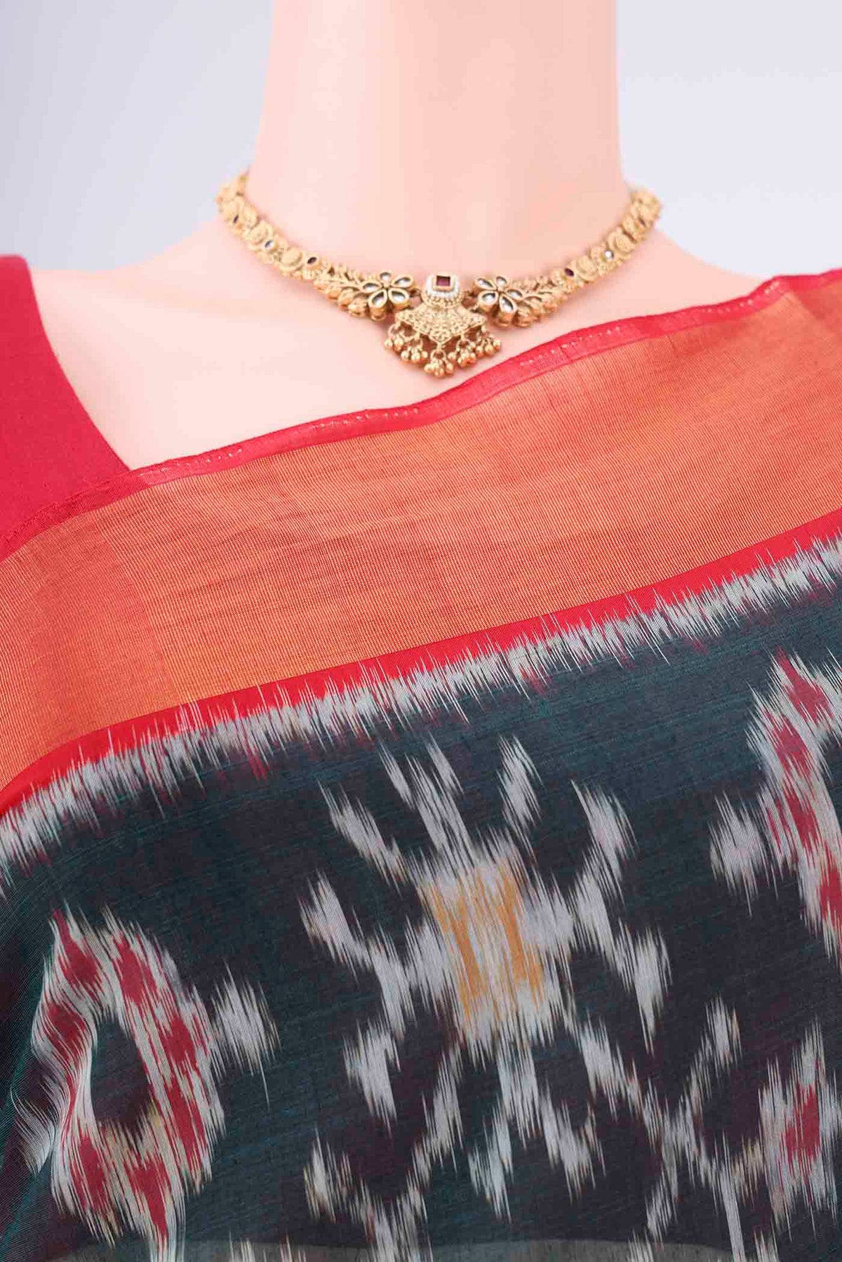 Border image of Bottle Green Kora Cotton Saree with Ikat design on the body and Zari Border. 