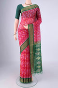 Rani Pink Silk Cotton Saree with Ikat design on the body and Zari Border.  displayed on a mannequin