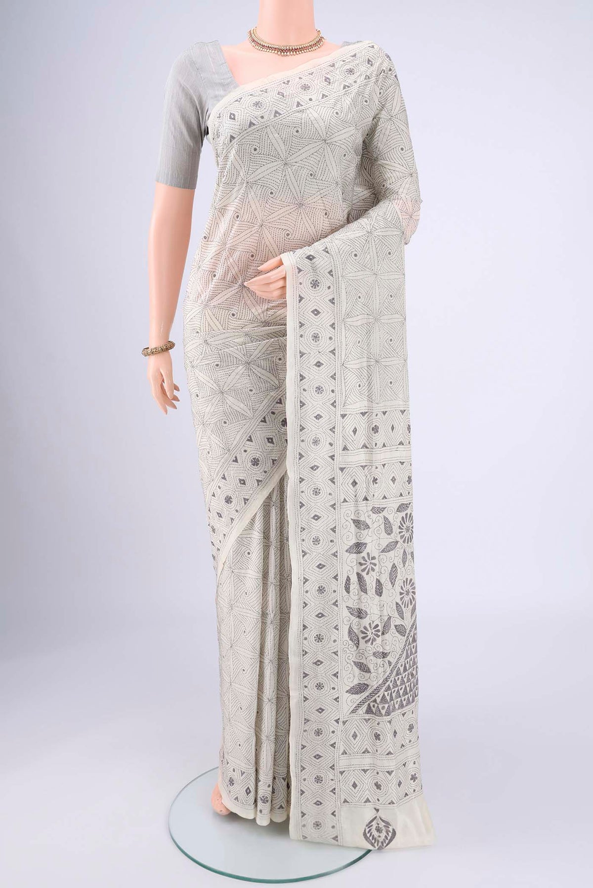 White Kantha Silk Saree with Kantha Work on the body and Thread Border.  displayed on a mannequin