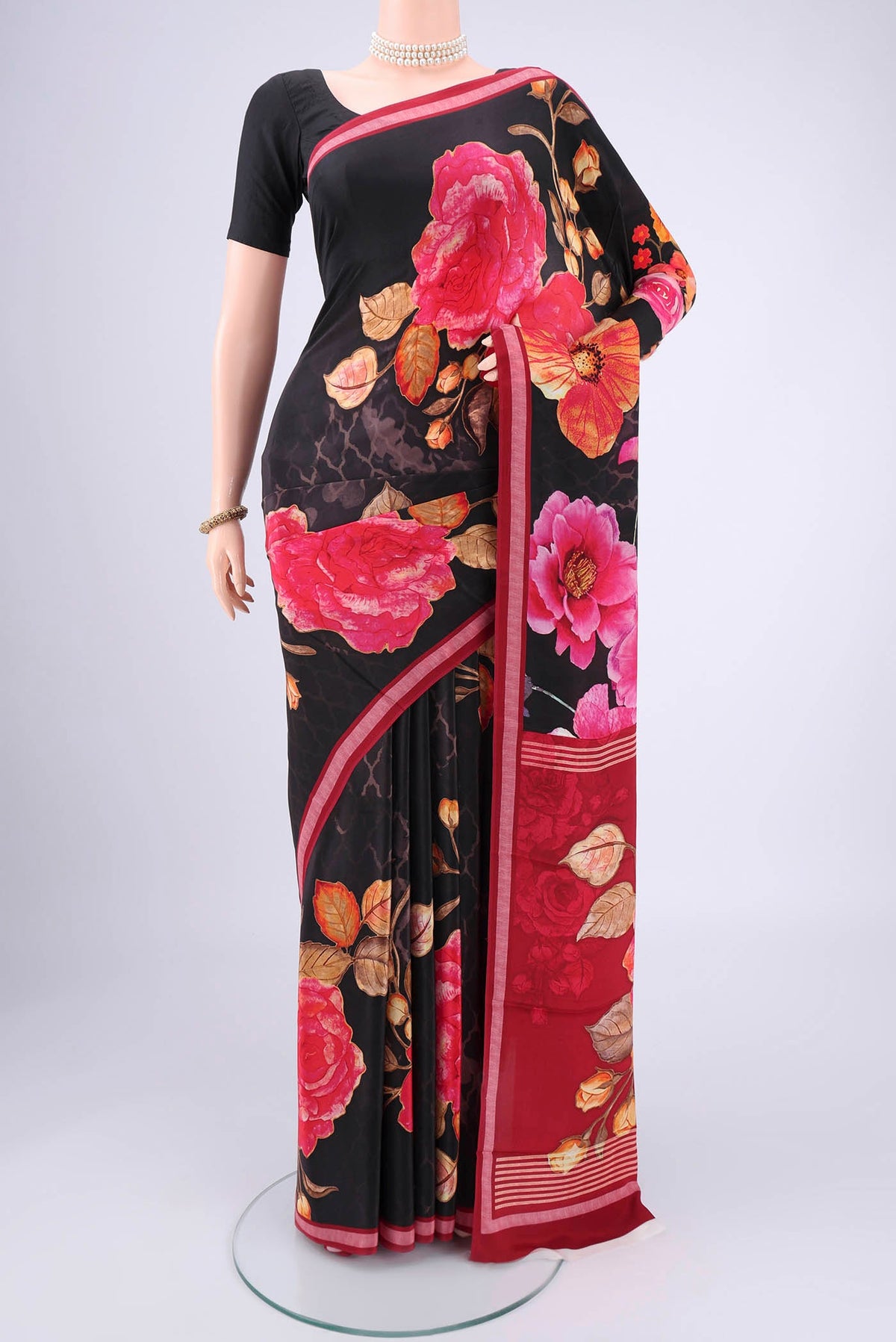 Black Mysore Crepe Saree with Floral Print on the body and Zari Border.  displayed on a mannequin
