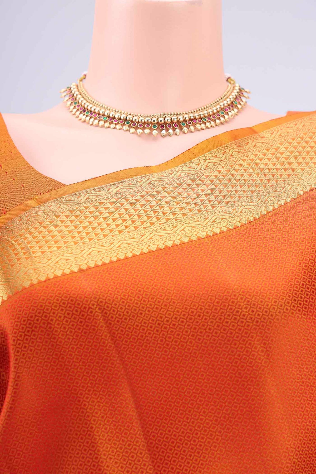 Border image of Rust Kanjivaram Silk Saree with Jacquard design on the body and Zari Border. 