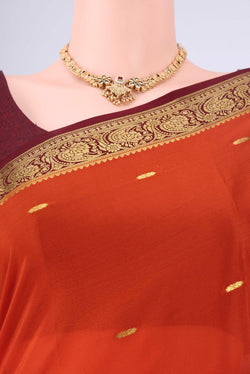 Rust Mysore Georgette Saree with Zari Butta on the body and Zari Border.  displayed on a mannequin