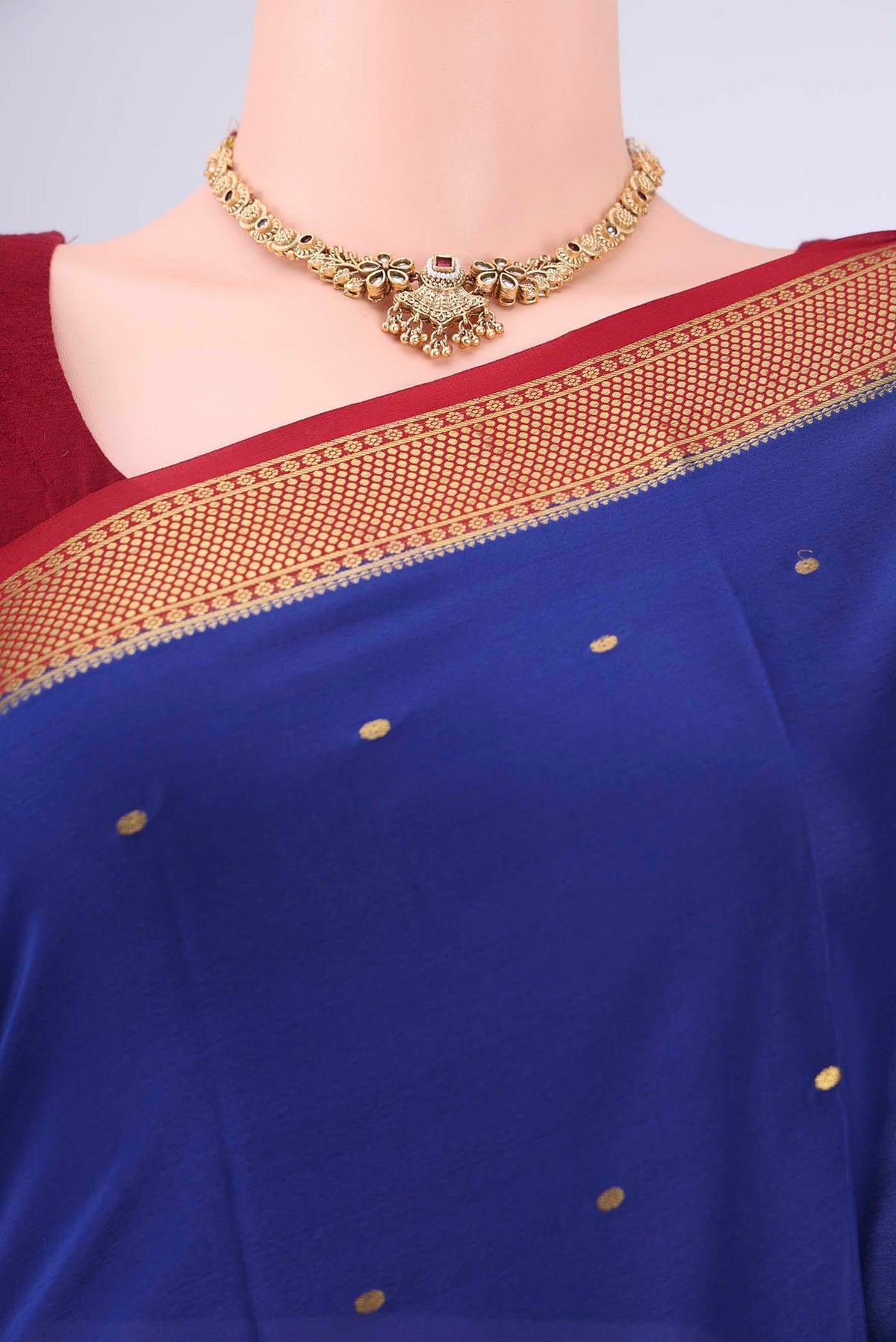 Royal Blue Mysore Georgette Saree with Zari Butta on the body and Zari Border.  displayed on a mannequin