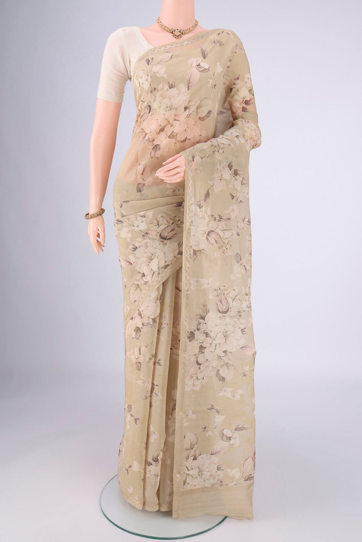 Dark Beige Chanderi Silk Cotton Saree with Floral Print on the body and Zari Border.  displayed on a mannequin