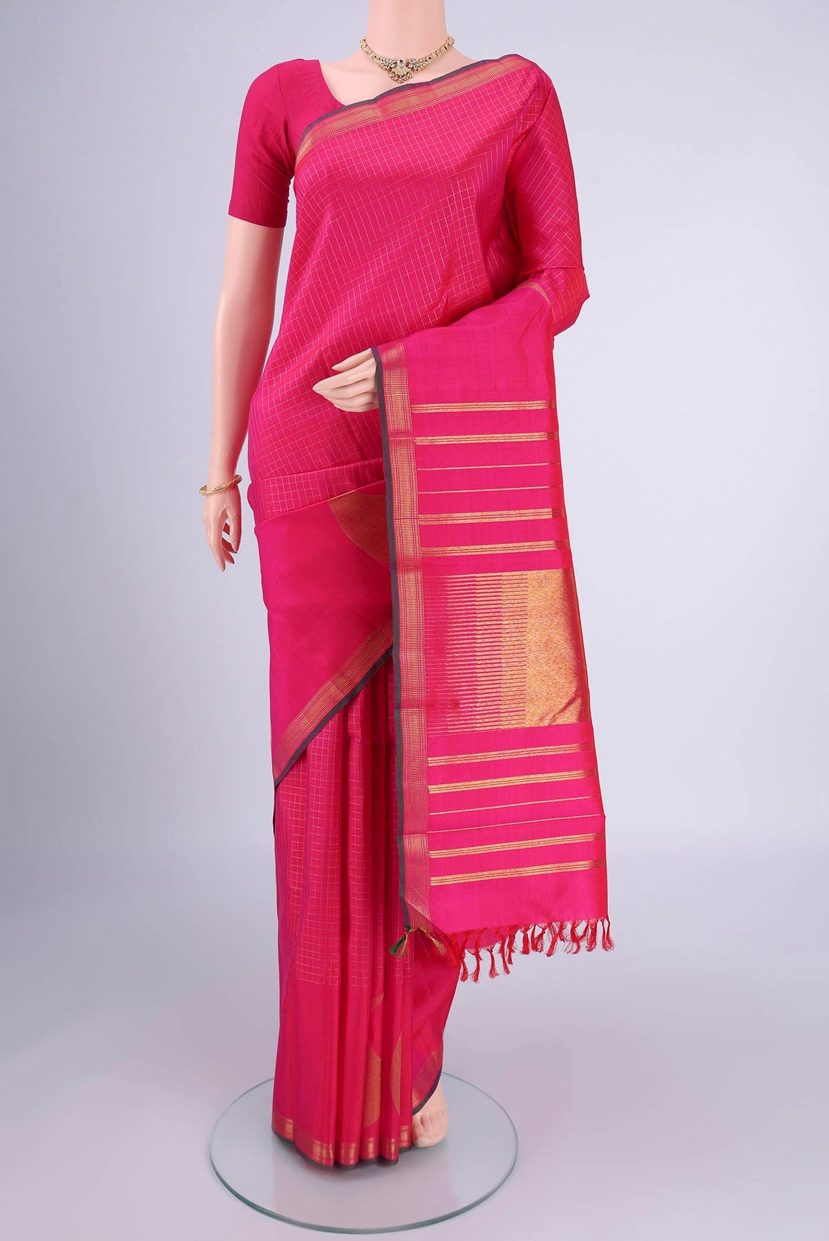 Pure Silk Pure Zari Rani Pink Kanchipuram Saree with Checked design on the body and Zari Border.  displayed on a mannequin