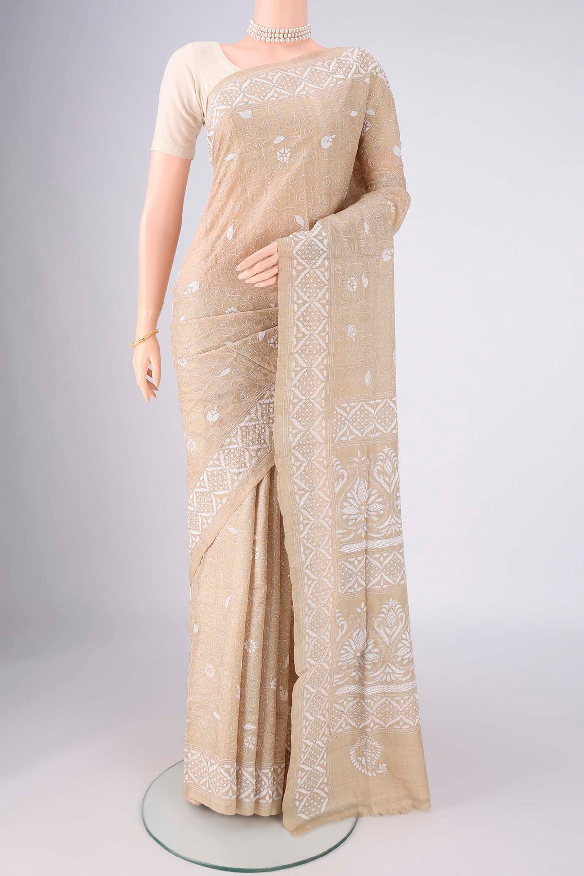 Beige Tussar Silk Saree with Kantha Work on the body and Thread Border.  displayed on a mannequin