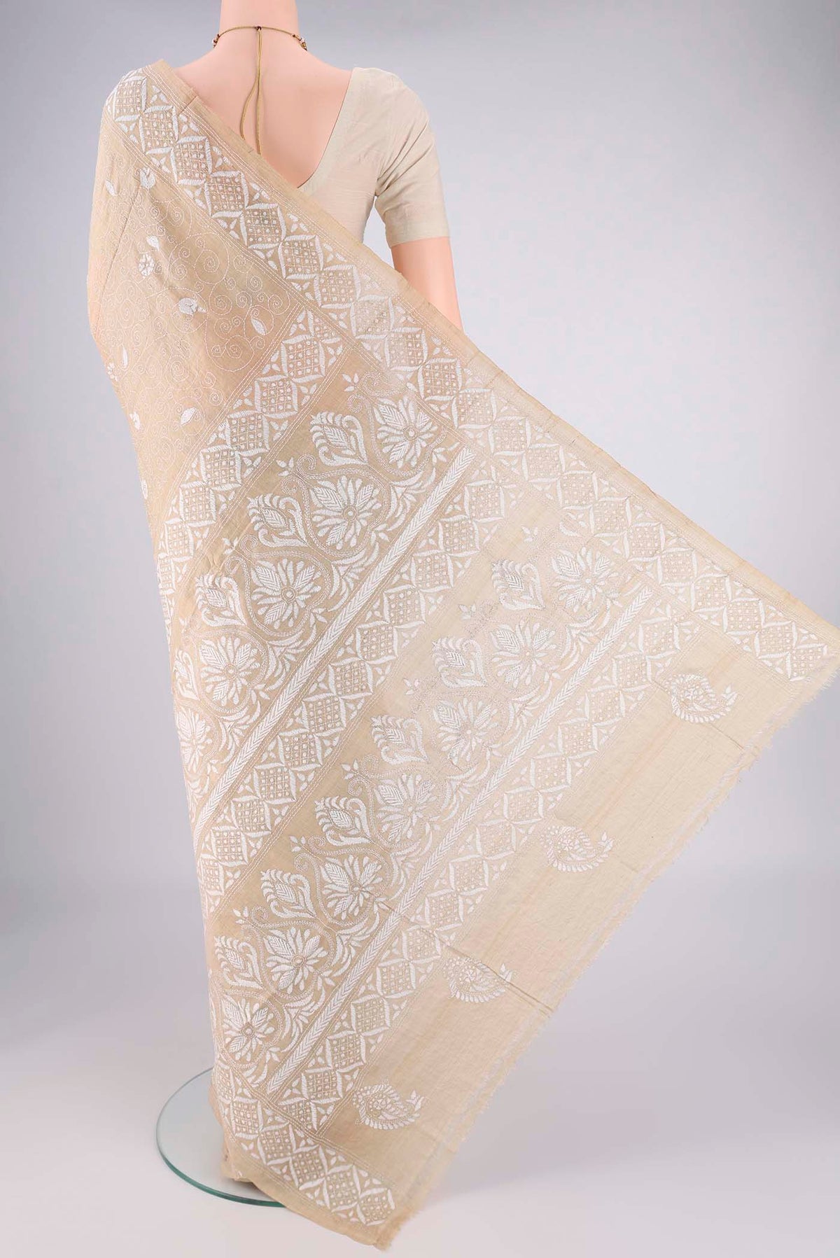 Flat view of Beige Tussar Silk Saree with Kantha Work on the body and Thread Border. 