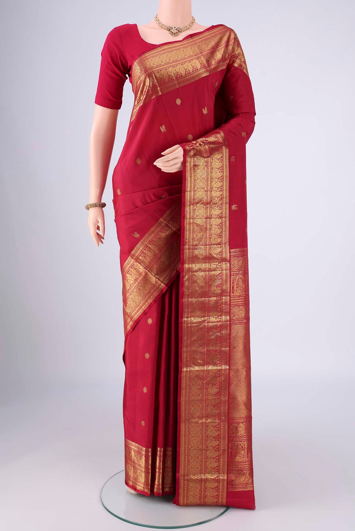 Maroon Dual Tone Kanjivaram Saree with Zari Butta on the body and Zari Border.  displayed on a mannequin