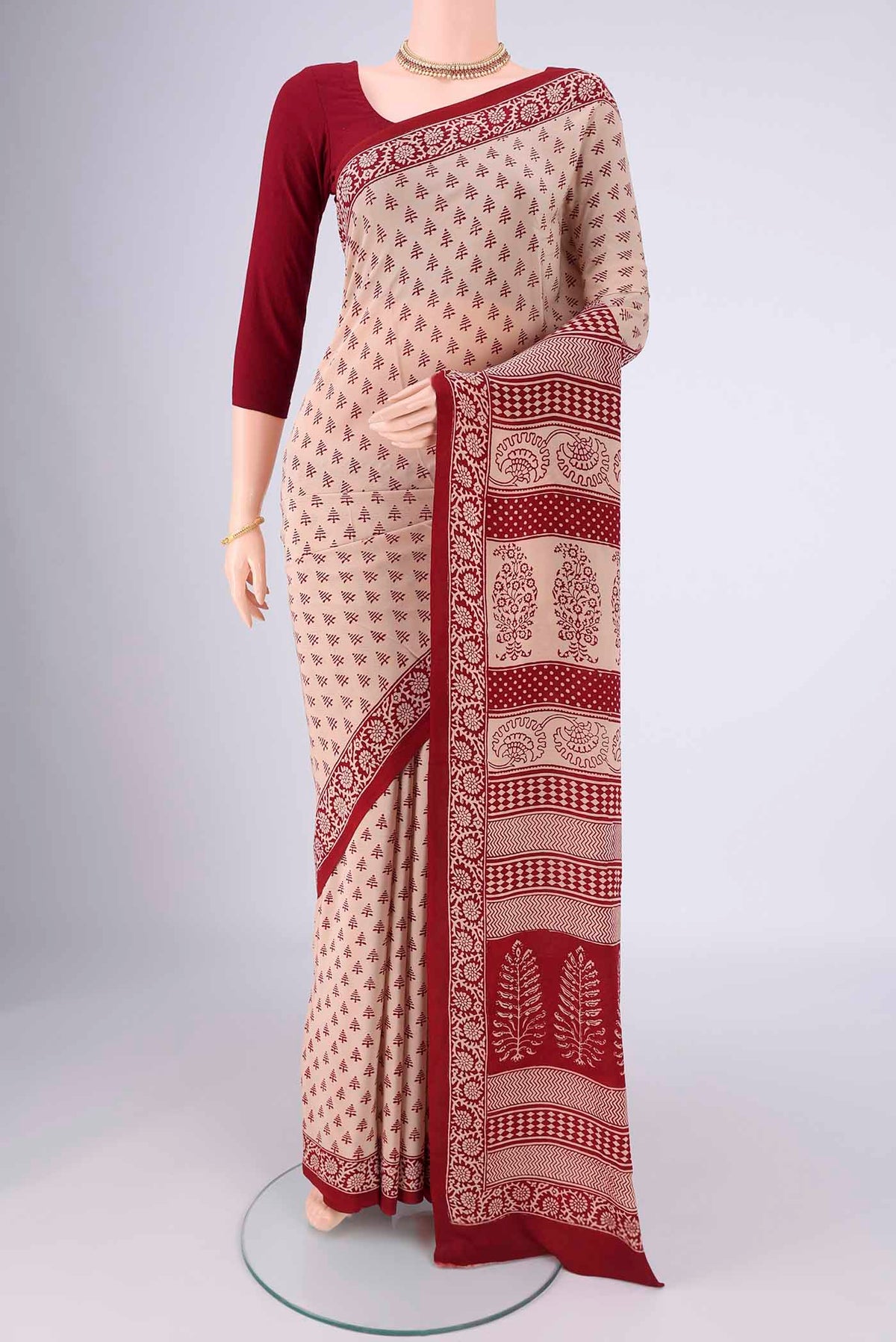 Beige Mysore Crepe Saree with Printed design on the body and Printed Border.  displayed on a mannequin