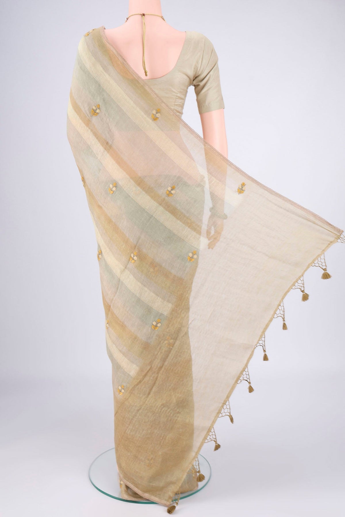 Flat view of Sage Green Linen Saree with Embroidery on the body and Lace Border. 