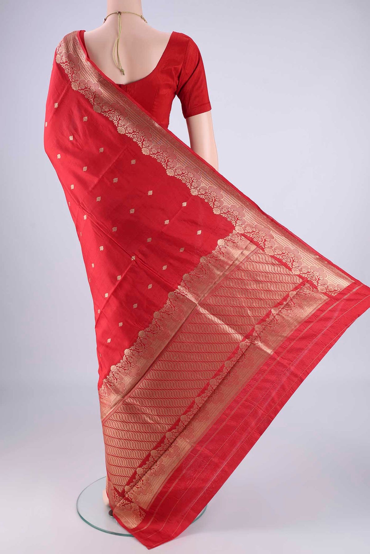 Flat view of Red Banarasi Katan Silk Saree with Zari Butta on the body and Zari Border. 