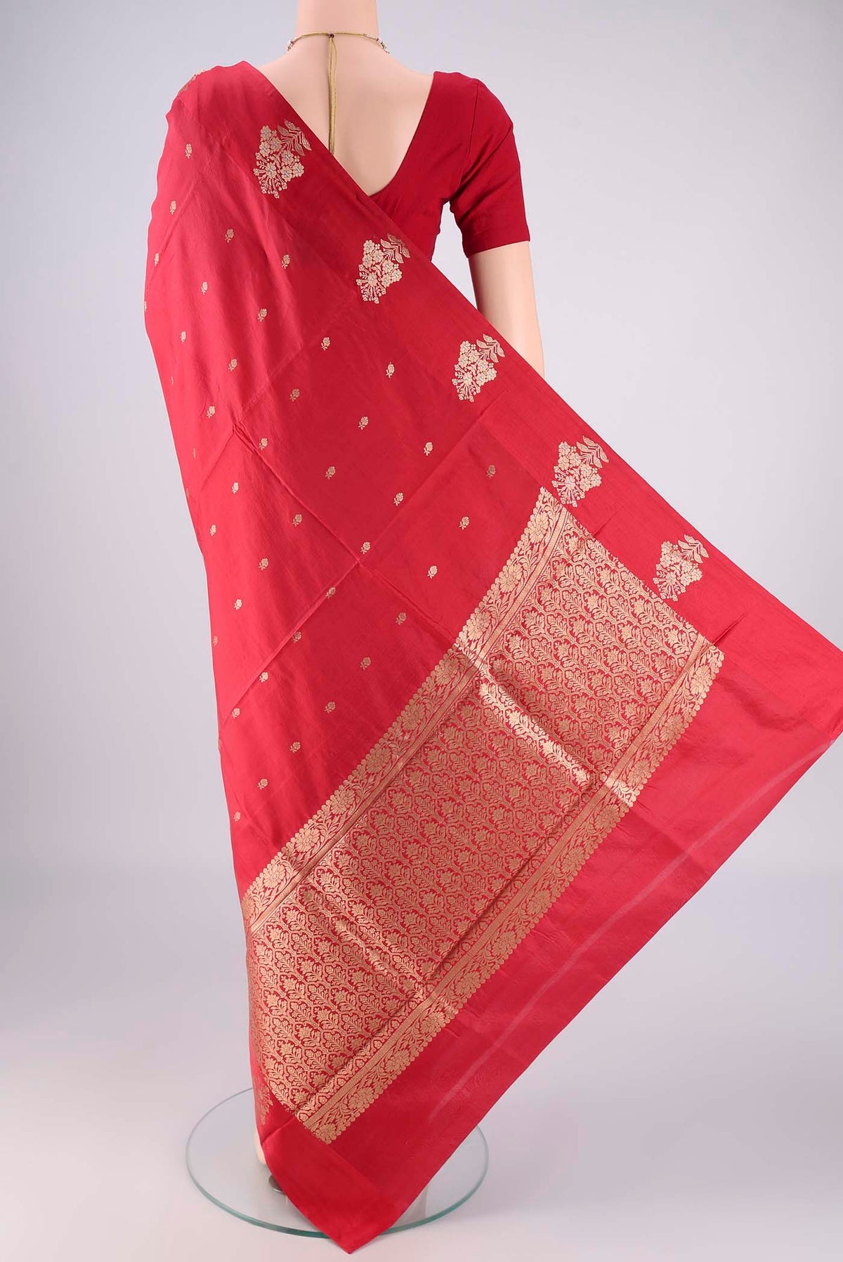 Flat view of Red Banarasi Katan Silk Saree with Zari Butta on the body and Plain Border. 