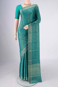 Turquoise Mysore Crepe Saree with Zari Butta on the body and Zari Border.  displayed on a mannequin