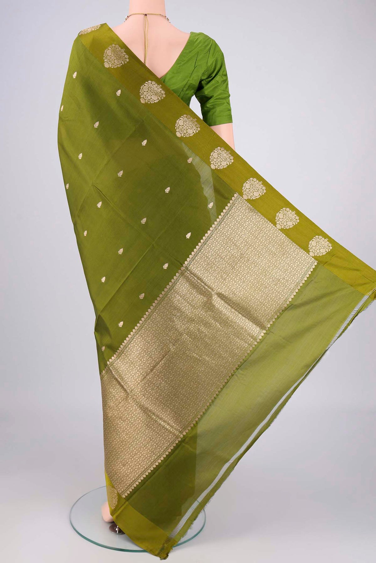 Flat view of Mehandi Green Banarasi Katan Silk Saree with Zari Butta on the body and Plain Border. 