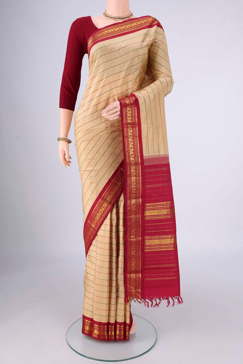 Beige Kanchipuram Silk Saree with Veldhari on the body and Zari Border.  displayed on a mannequin