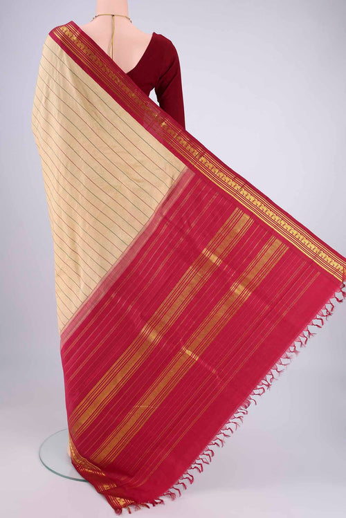 Flat view of Beige Kanchipuram Silk Saree with Veldhari on the body and Zari Border. 