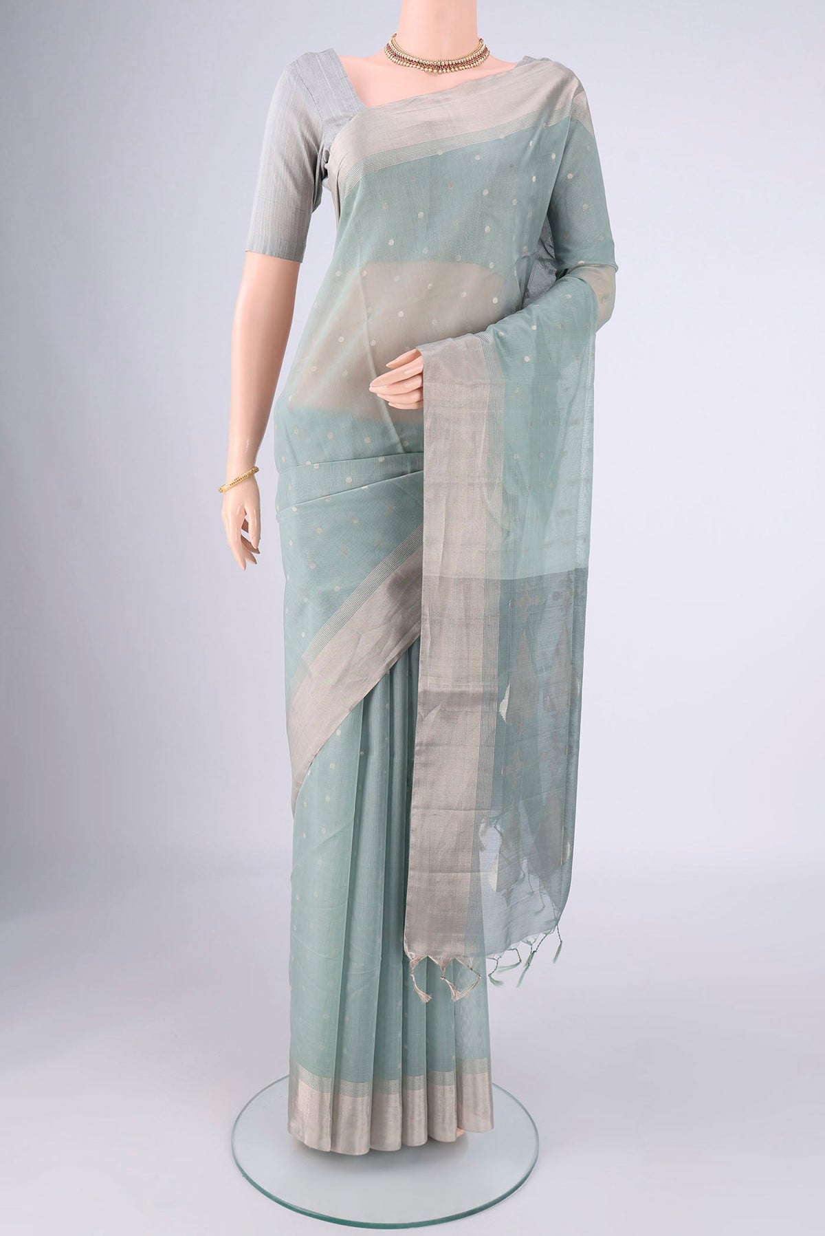 Grey Silk Cotton Saree with Zari Butta on the body and Zari Border.  displayed on a mannequin