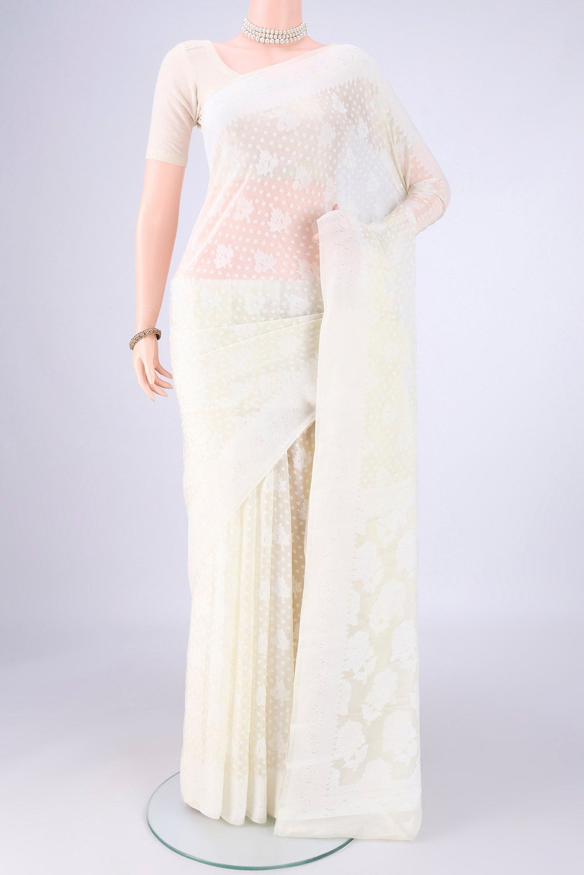 Off White Blended Banarasi Georgette Saree with Thread Butta on the body and Thread Border.  displayed on a mannequin