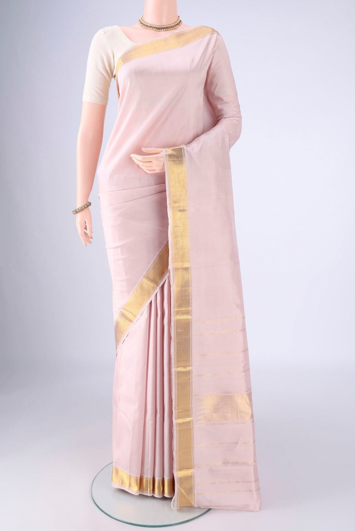 Rose pink Kanjivaram Silk Saree with Plain Body and Zari Border.  displayed on a mannequin