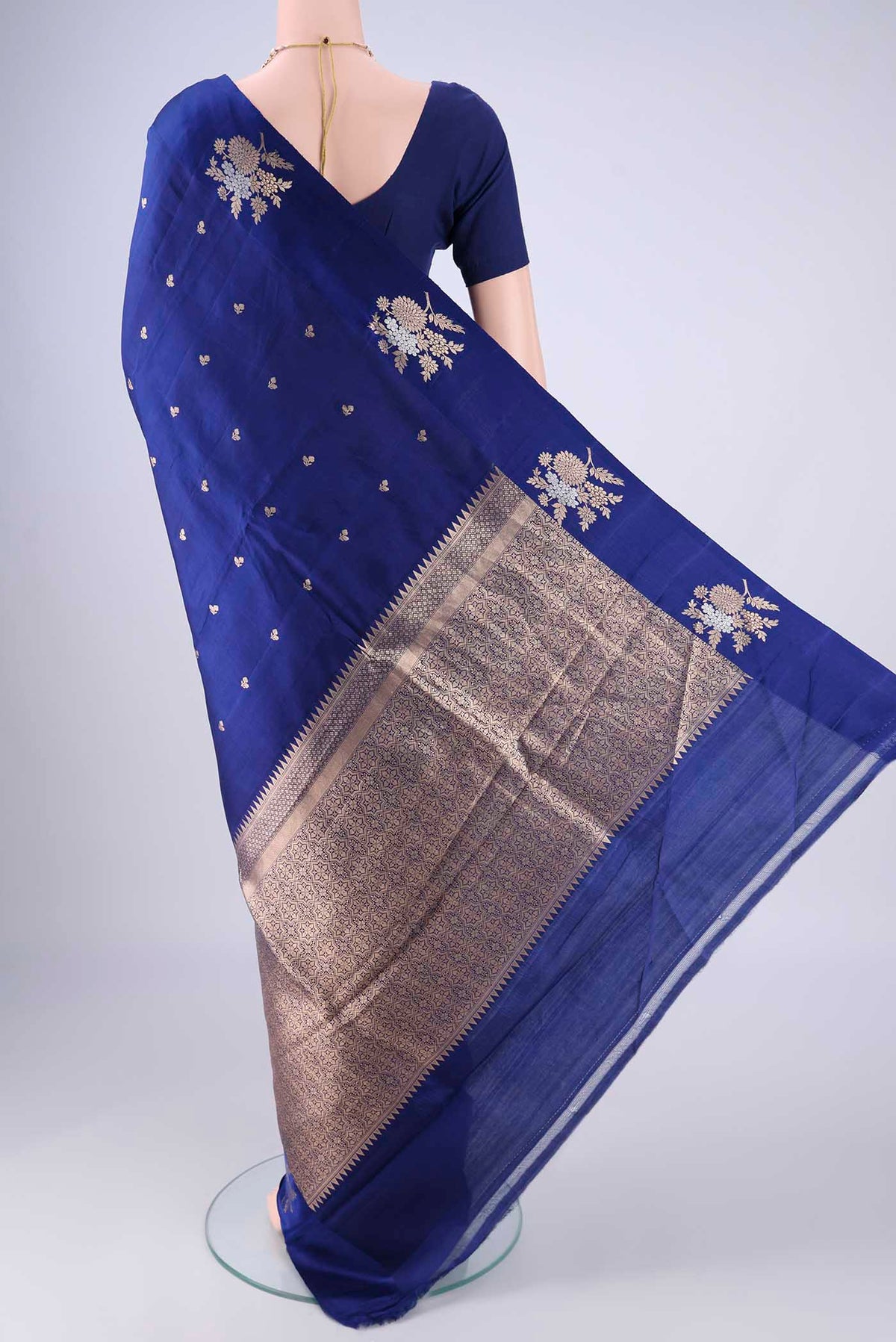 Flat view of Dark Blue Banarasi Katan Silk Saree with Zari Butta on the body and Satin Border. 