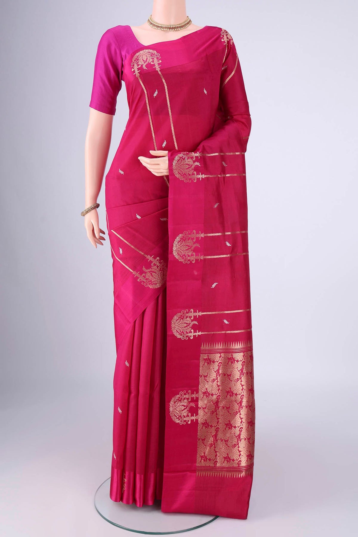 Rani Pink Banarasi Katan Silk Saree with Zari Butta on the body and Satin Border.  displayed on a mannequin