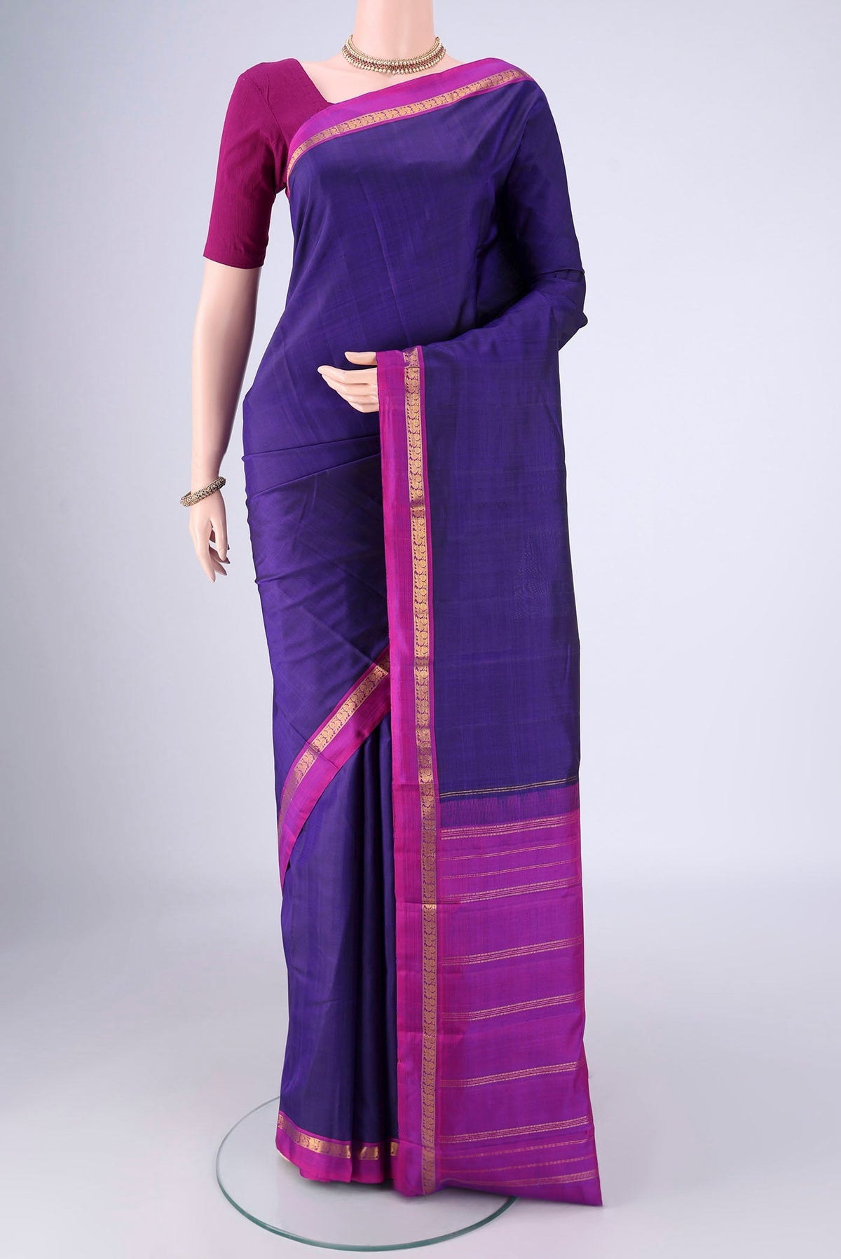 Blue Kanjivaram Silk Saree with Plain Body and Zari Border.  displayed on a mannequin