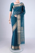Peacock Blue Silk Cotton Saree with Zari Butta on the body and Zari Border.  displayed on a mannequin