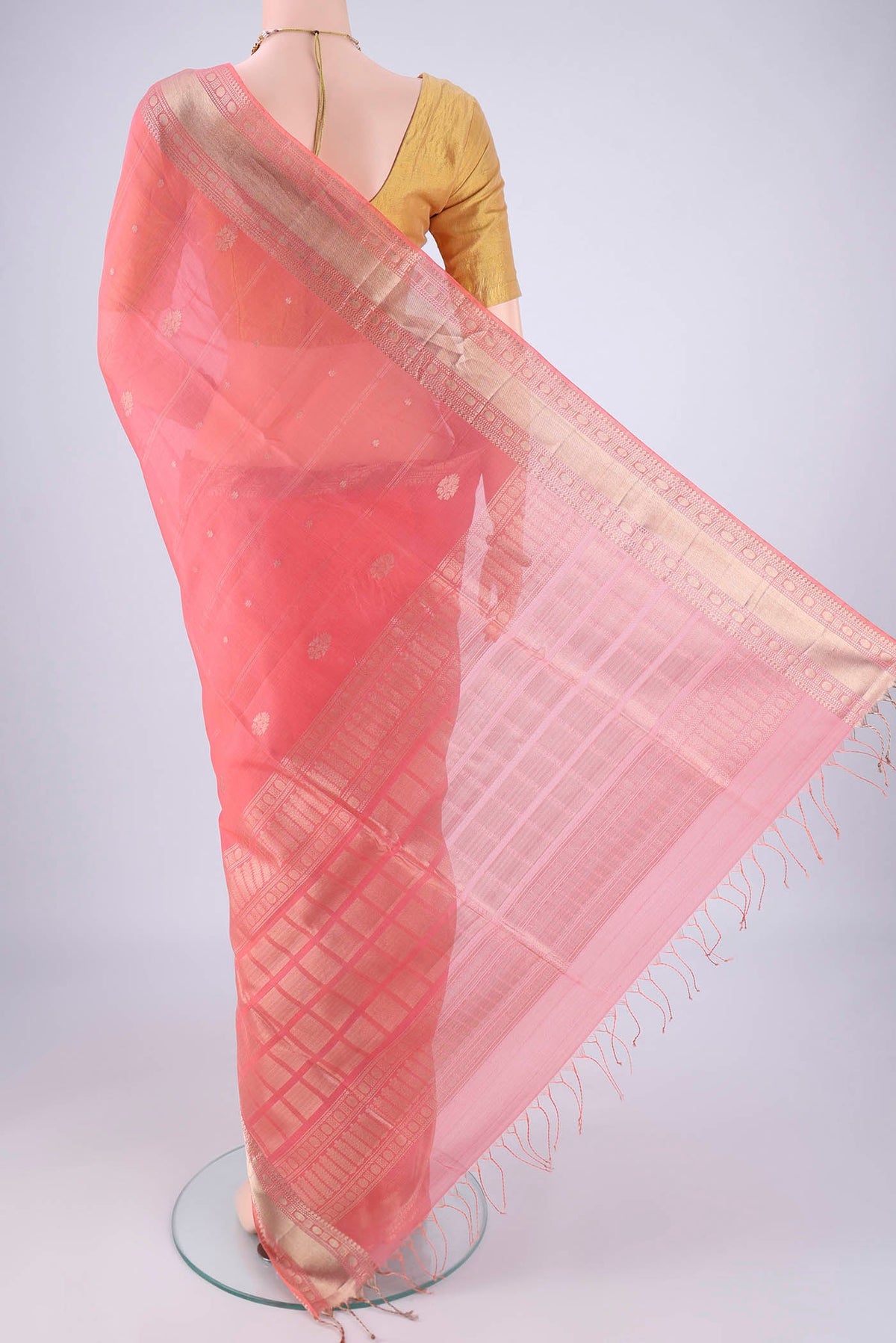 Flat view of Peach Silk Cotton Saree with Zari Butta on the body and Zari Border. 