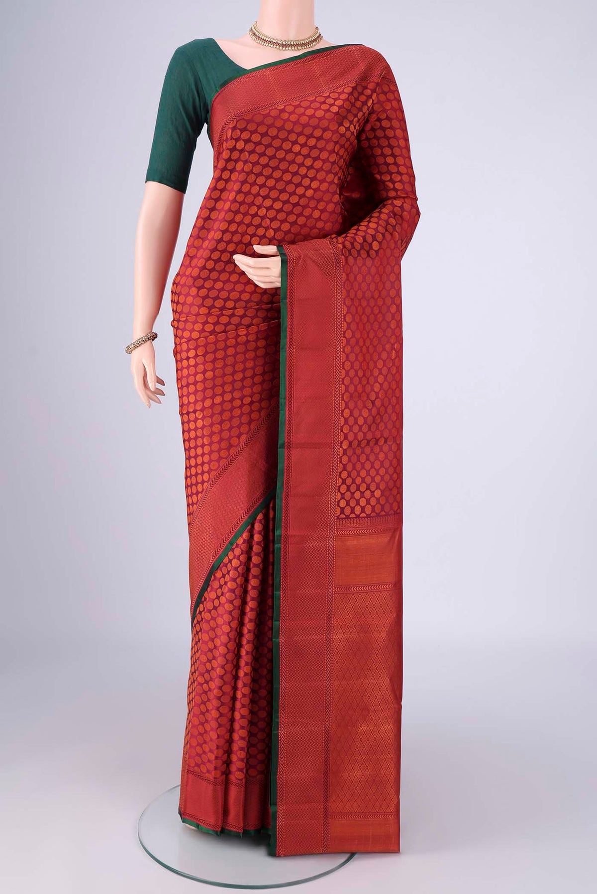 Maroon Kanchipuram Silk Saree with Jacquard design on the body and Thread Border.  displayed on a mannequin