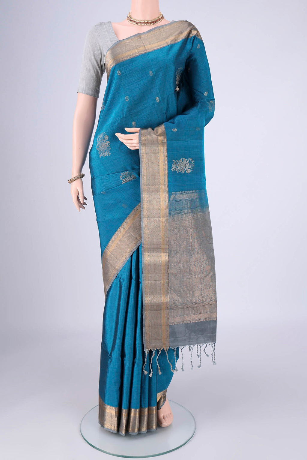 Blue Soft Silk Saree with Zari Butta on the body and Zari Border.  displayed on a mannequin