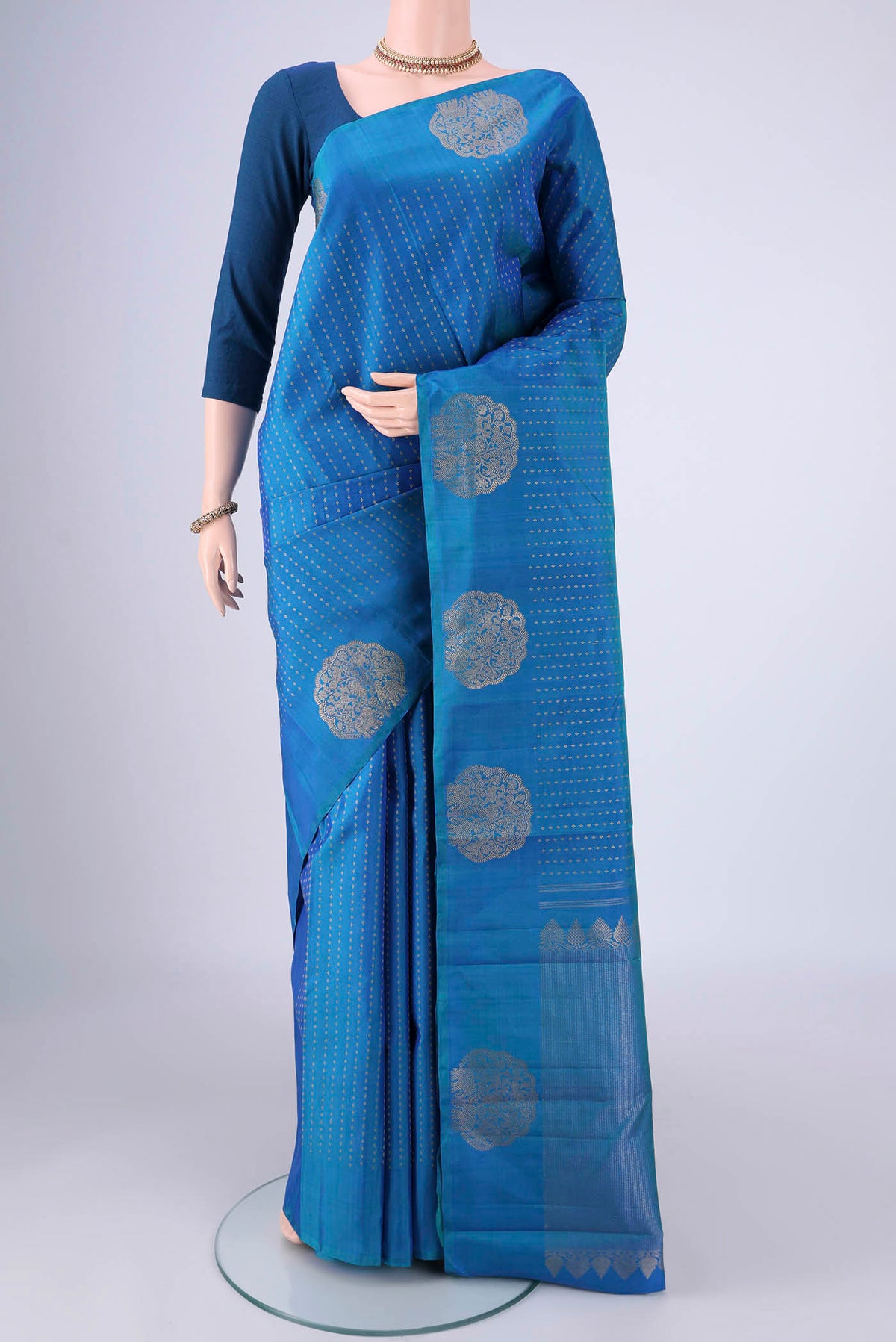 Blue Kanchipuram Silk Saree with Zari Butta on the body and Fancy Border.  displayed on a mannequin