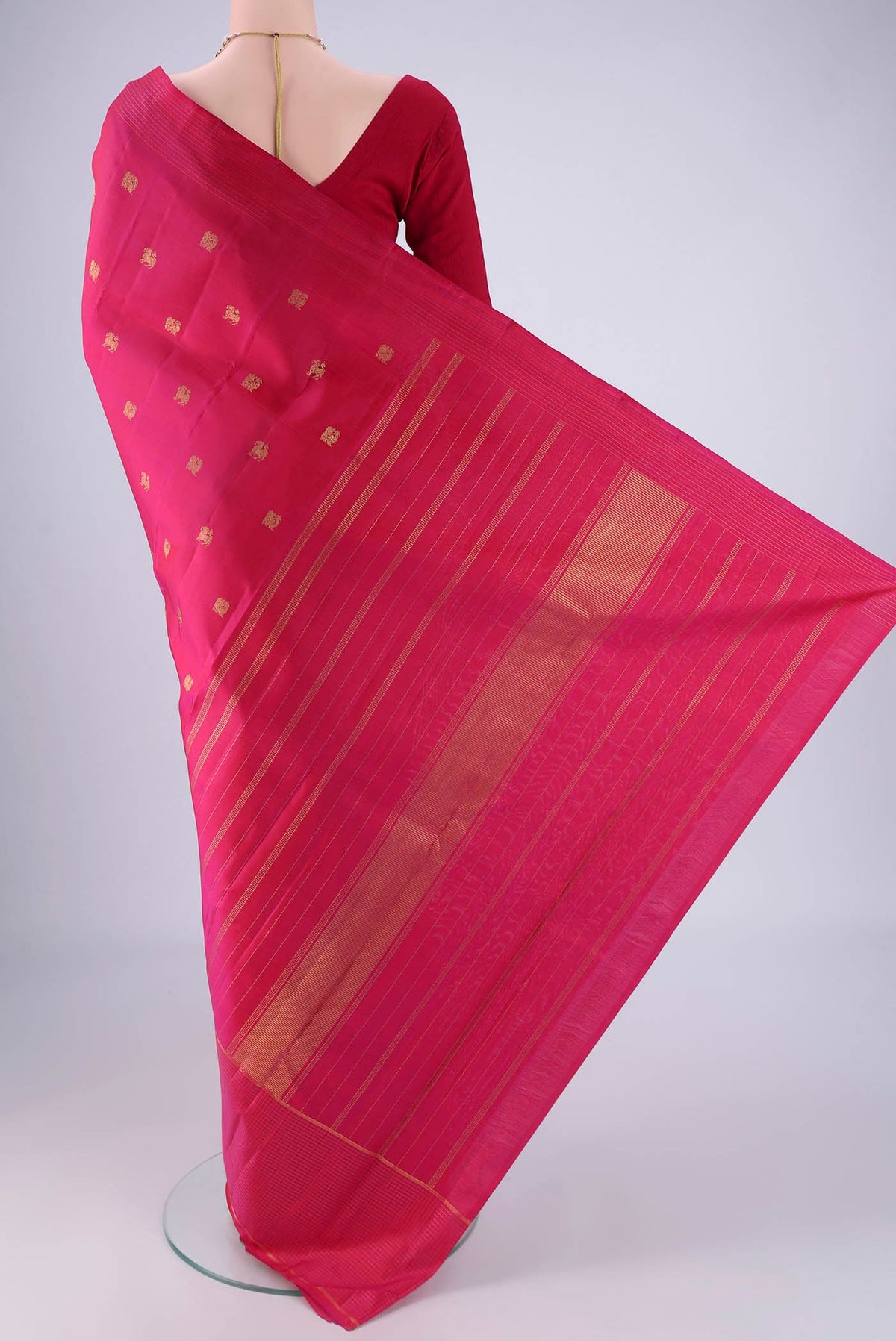 Flat view of Pure Silk Pure Zari Dark Pink Kanchipuram Saree with Zari Butta on the body and Zari Border. 