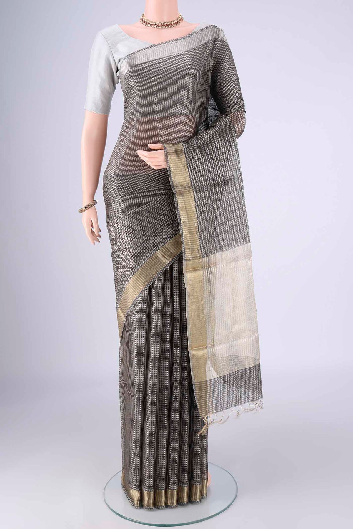 Davys Grey Tussar Silk Saree with Checked design on the body and Zari Border.  displayed on a mannequin