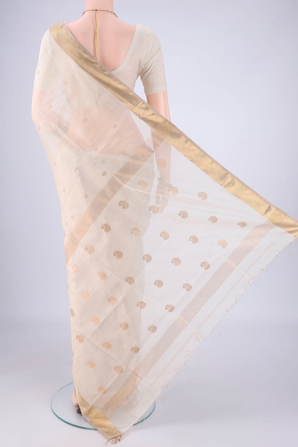 Flat view of Cream Maheshwari Silk Cotton Saree with Zari Butta on the body and Zari Border. 