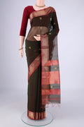 Bottle Green Dual Tone Maheshwari Silk Cotton Saree with Zari Butta on the body and Zari Border.  displayed on a mannequin