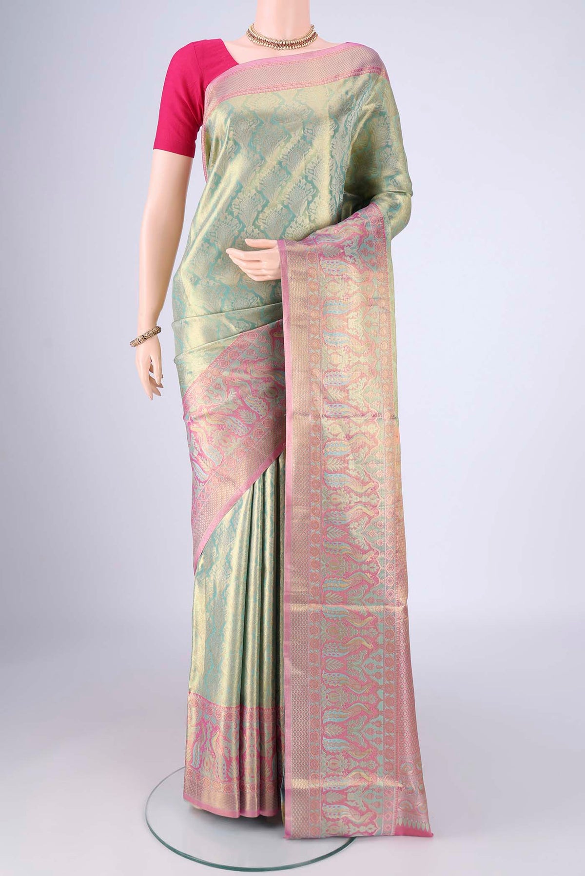 Sea Green Dual Tone Kanchipuram Tissue Silk Saree with Zari Brocade on the body and Zari Border.  displayed on a mannequin