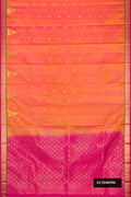 Coral Dual Tone Kanchipuram Silk Saree with Zari Butta on the body and Zari Border.  displayed on a mannequin