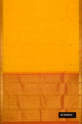 Yellow Dual Tone Kanchipuram Silk Saree with Zari Butta on the body and Zari Border.  displayed on a mannequin