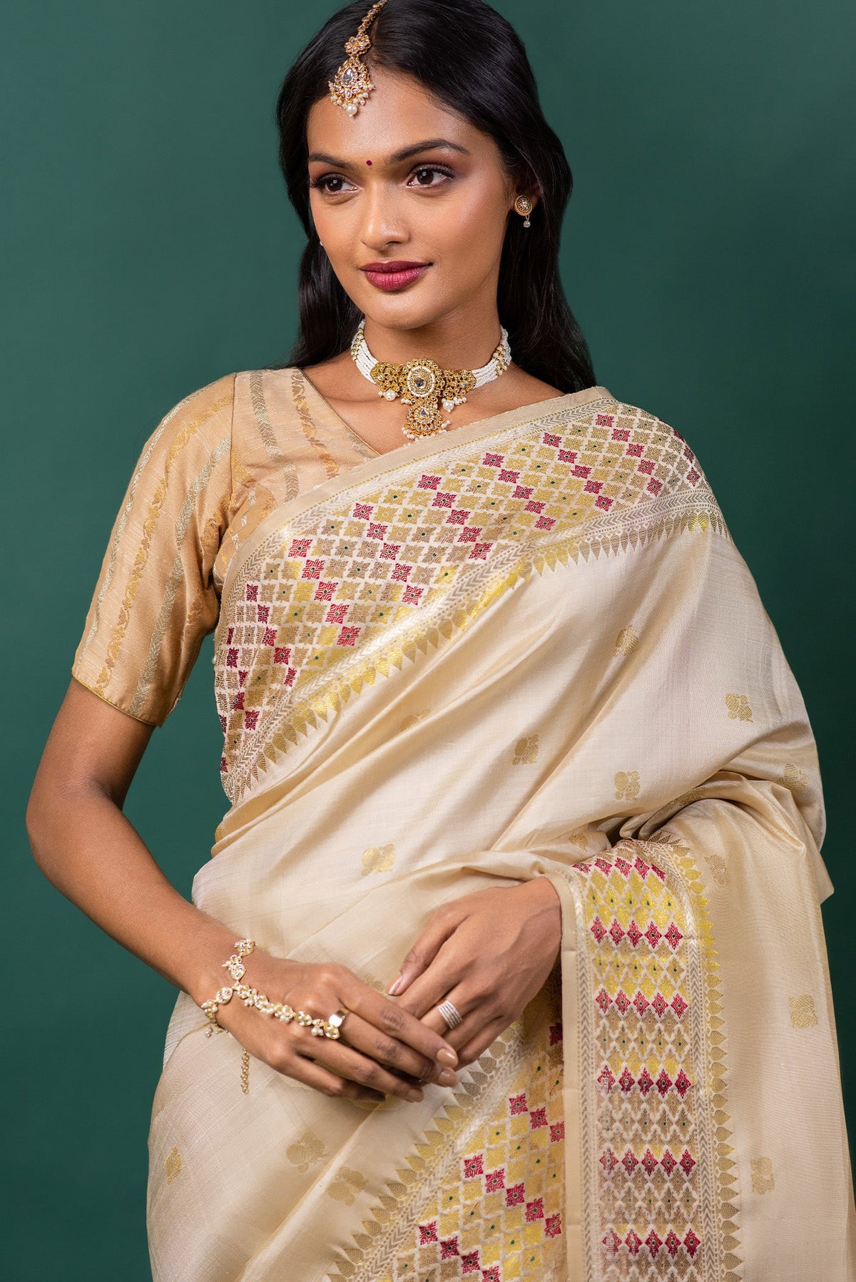 Close up of Beige Kanchipuram Silk Saree with Zari Butta on the body and Zari And Thread Border displaying folds