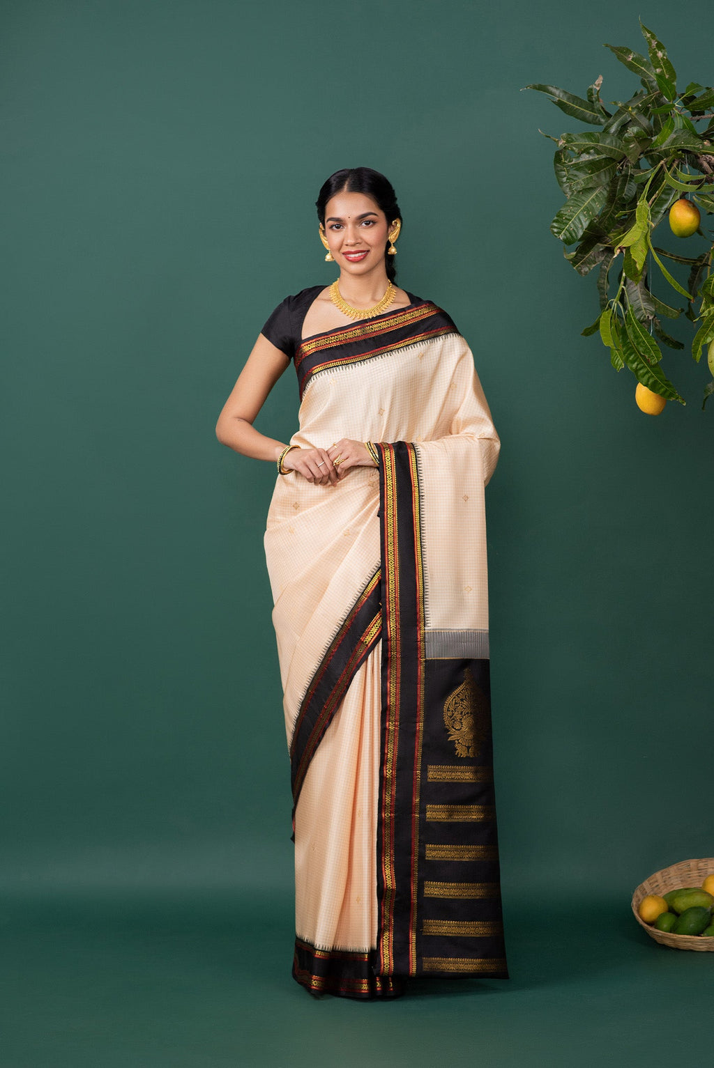 Off White Kanchipuram Silk Saree with Zari Butta on the body and Zari Border displayed on a mannequin