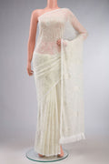 Cream Blended Chiffon Saree with Embroidery on the body and Lace Border.  displayed on a mannequin