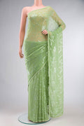 Green Blended Chiffon Saree with Embroidery on the body and Lace Border.  displayed on a mannequin