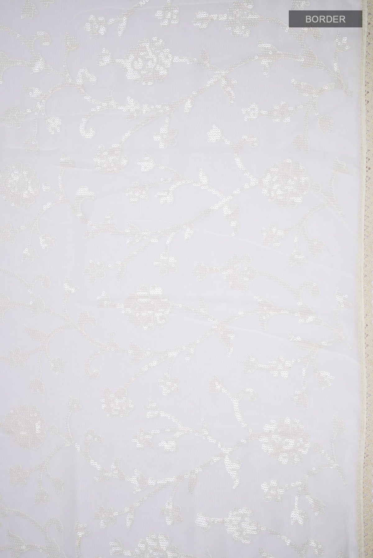 Border image of Cream Blended Chiffon Saree with Embroidery on the body and Lace Border. 