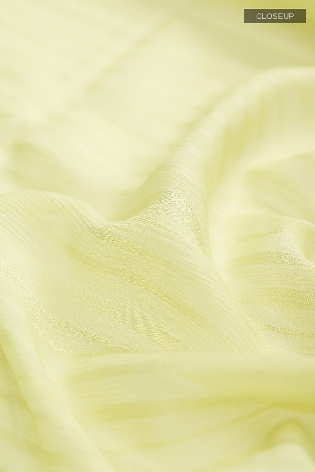 Close up of Green Mysore Chiffon Saree with Stripes on the body and Embroidery Border.  displaying folds